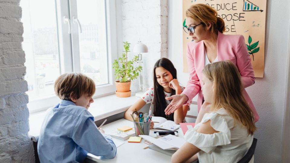 three middle school students with a teacher